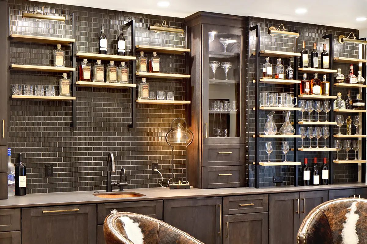 Finished dark wood bar cabinetry with glass display storage, wine storage, and integrated lighting