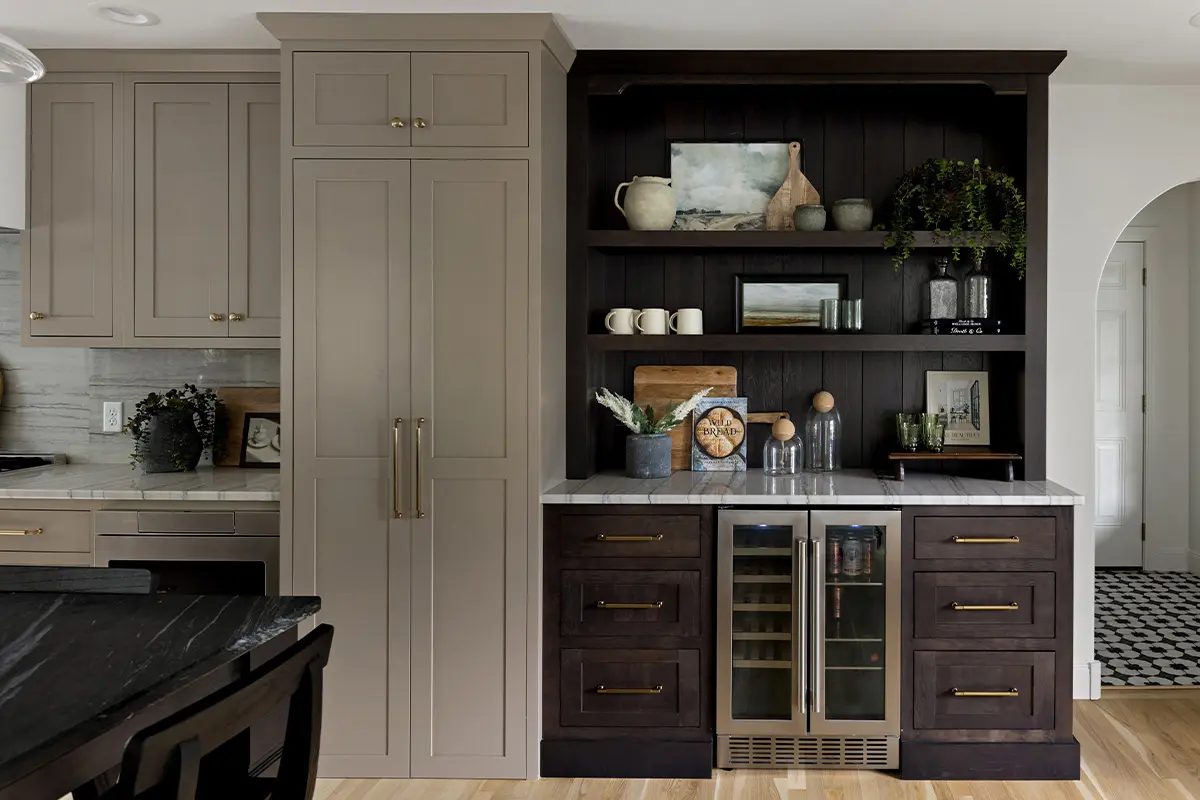 Finished inset cabinetry detail with dark lower cabinets, shelving, and a beverage refrigerator